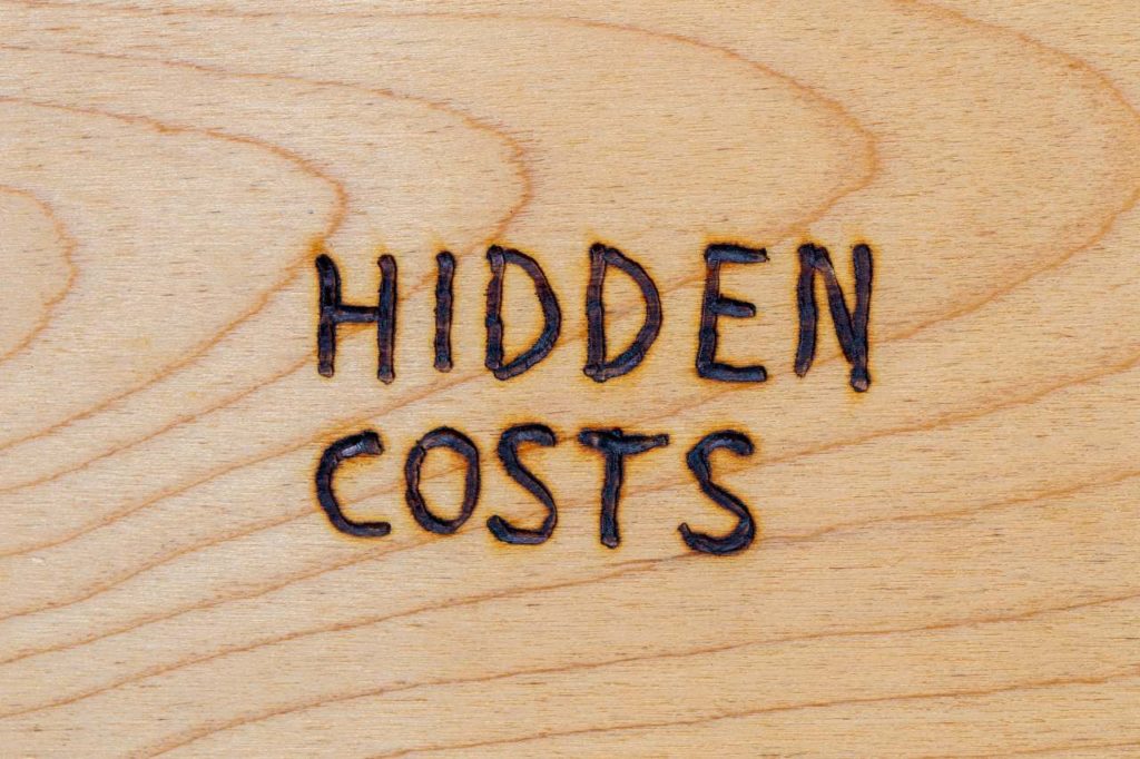 words hidden cost carved on a wood