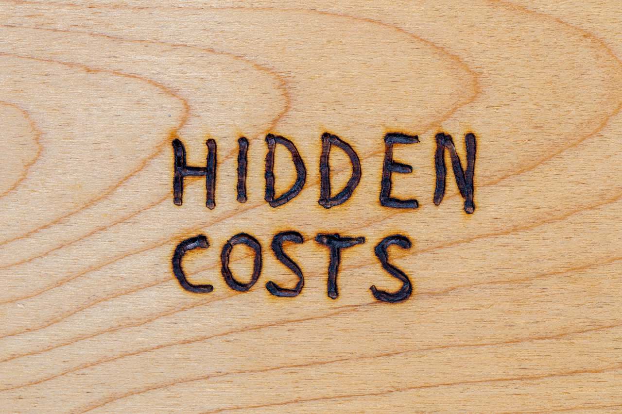 words hidden cost carved on a wood