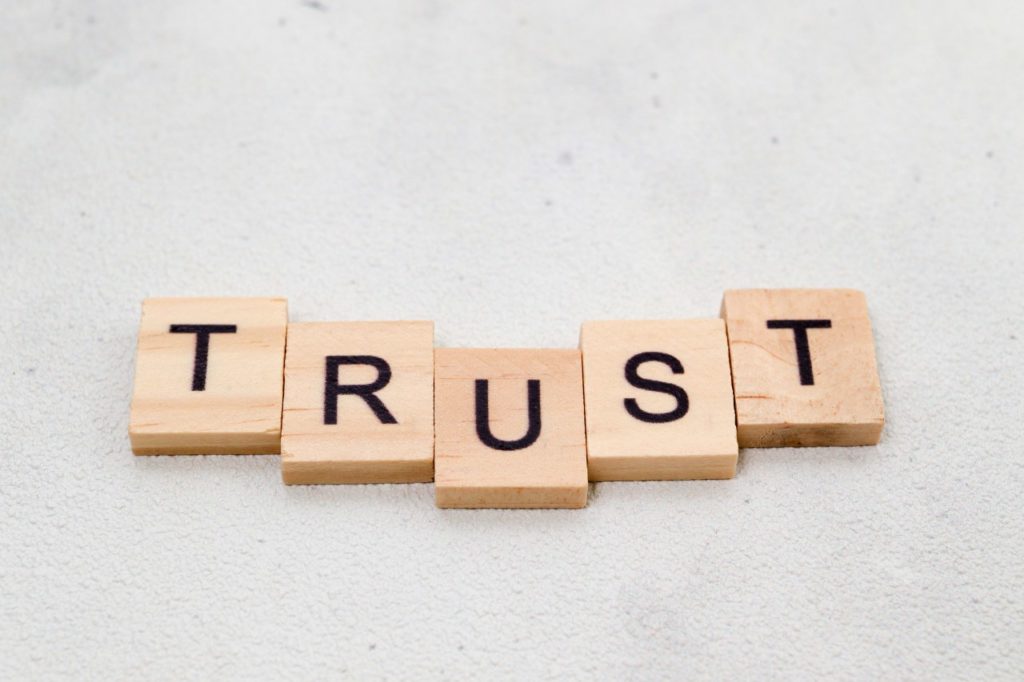word trust spelled in wooden tiles