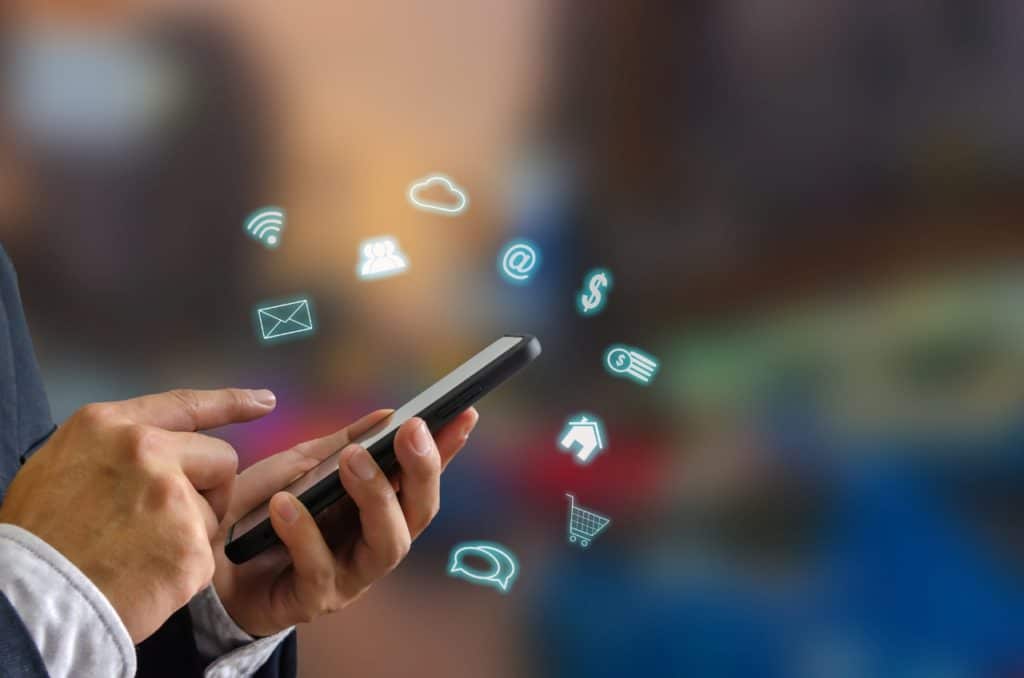 Person using a smart phone with digital icons