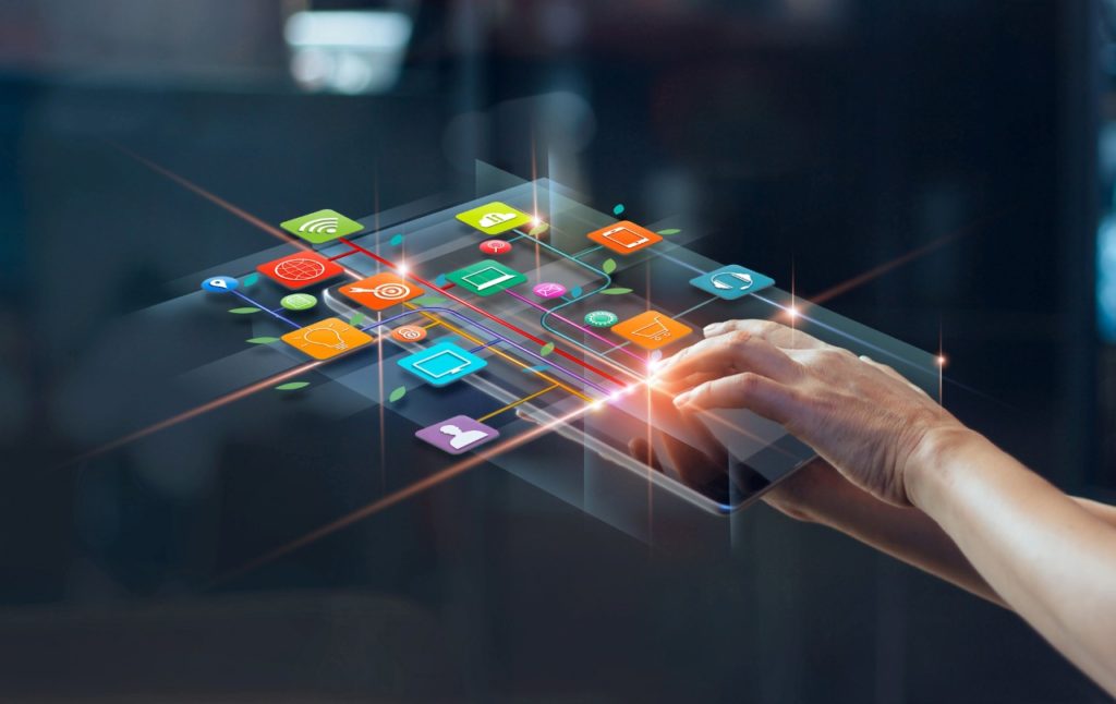 hands using a tablet with digital icons of apps