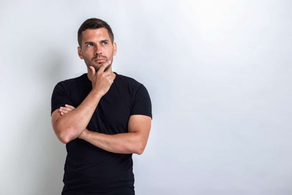 man wearing black thinking