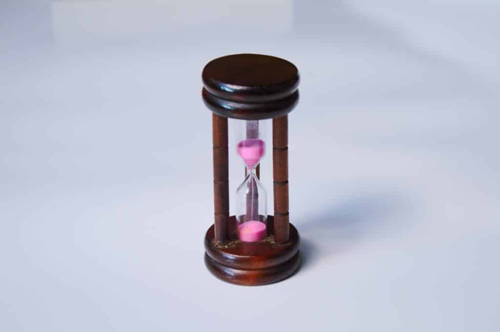 Hourglass with a wooden body and pink sand
