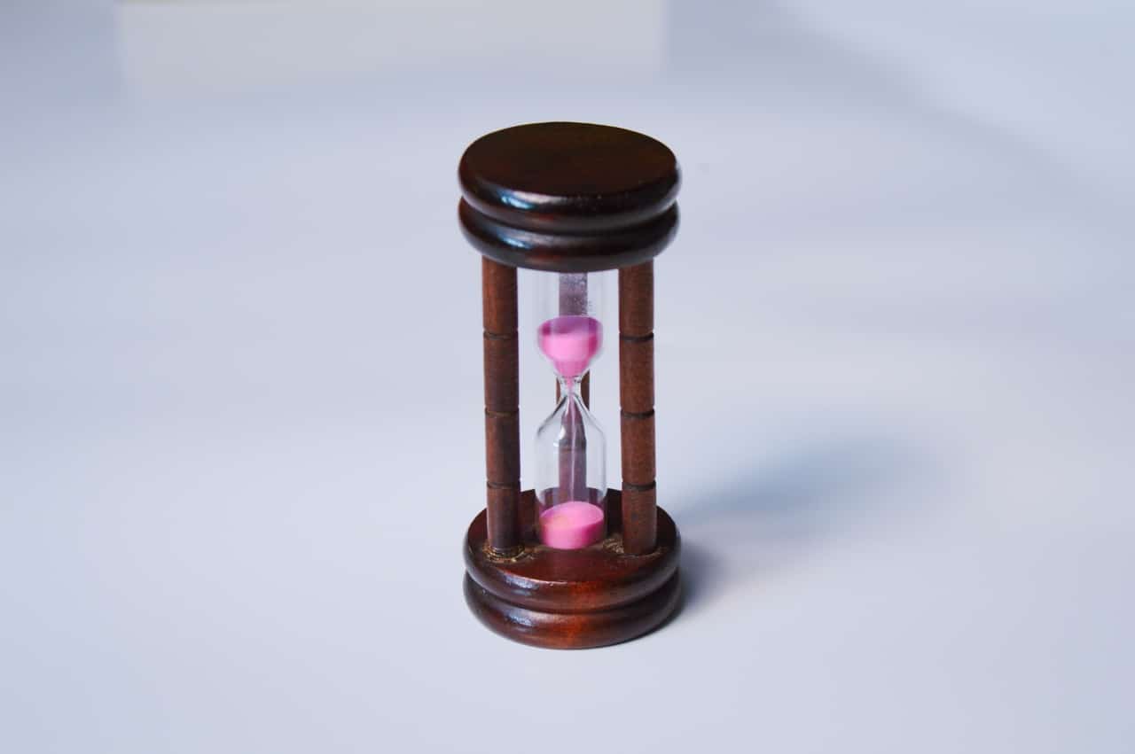 Hourglass with a wooden body and pink sand