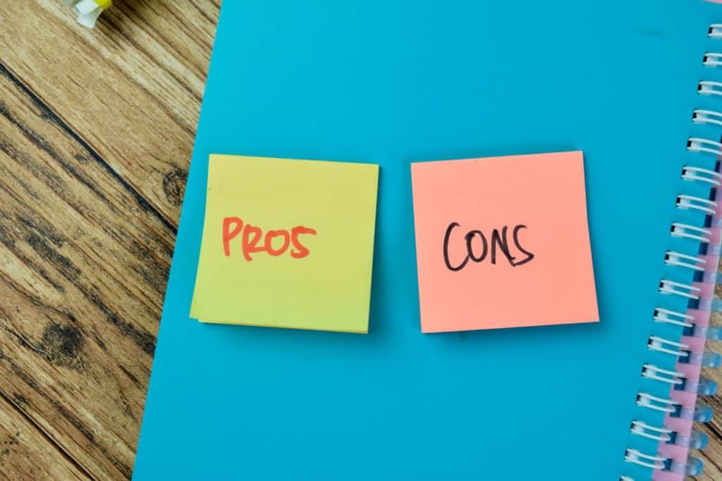 words pros and cons written on sticky notes